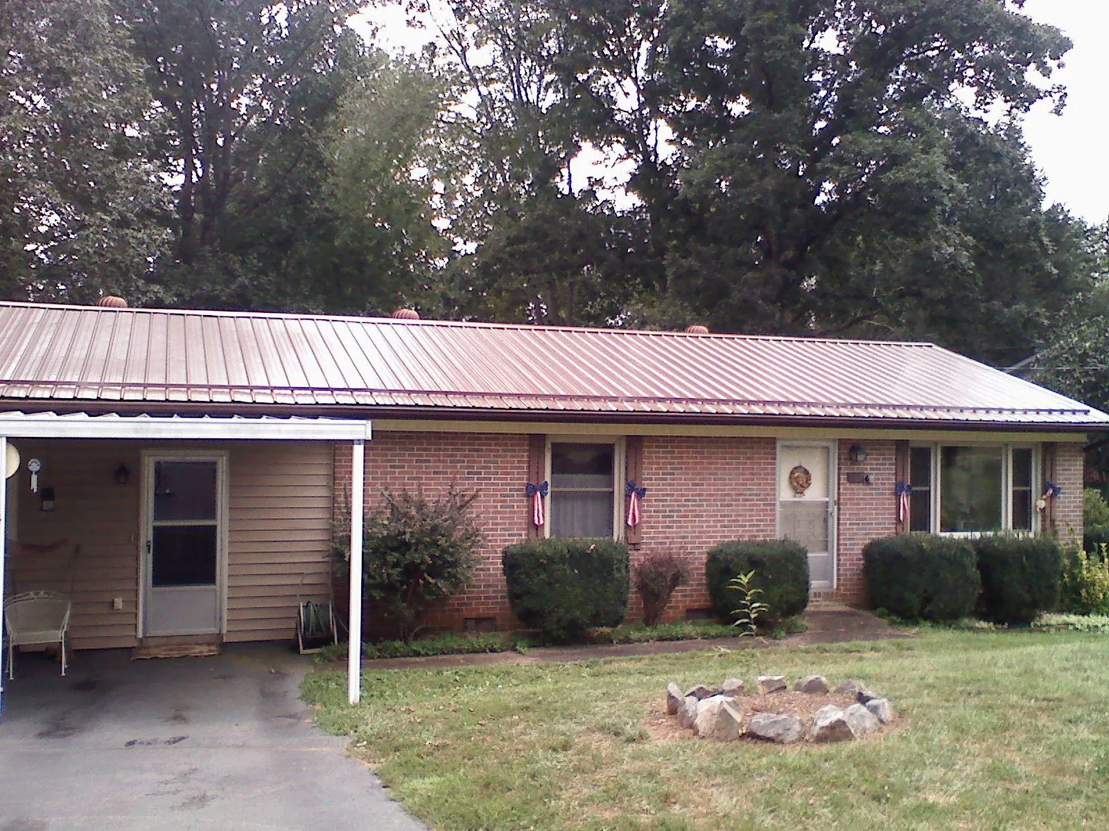 Bronze metal roof and carport on a brick ranch home — Roof Repair work by our crew in Mantoloking